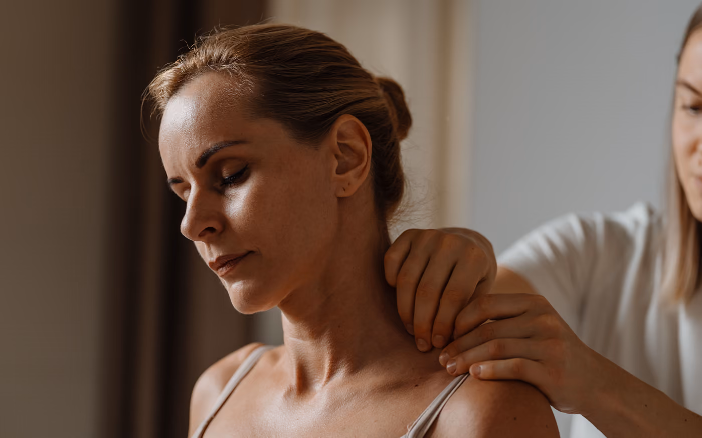 Calm client, the therapist’s hands on her neck